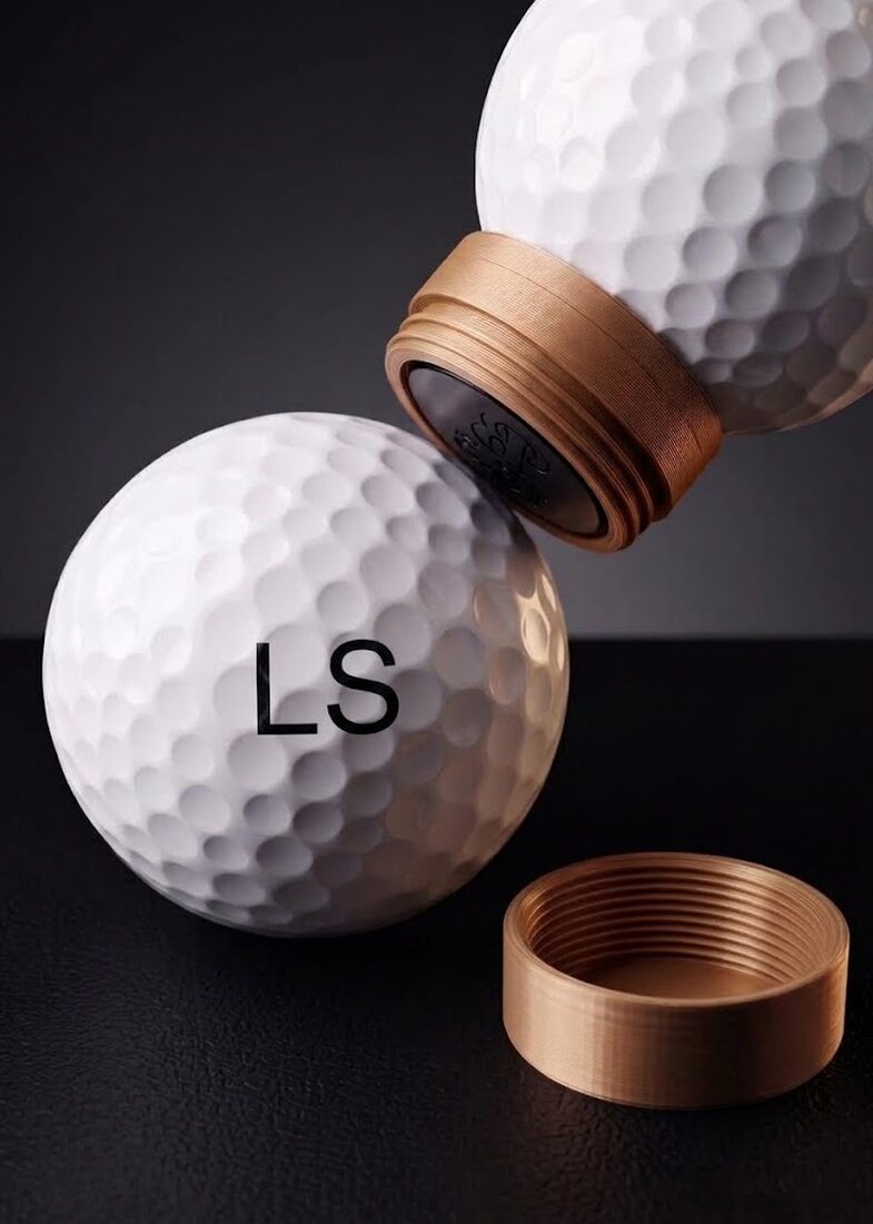Golf ball stamped with the initials LS, the Dimple¹ stamp lifting away