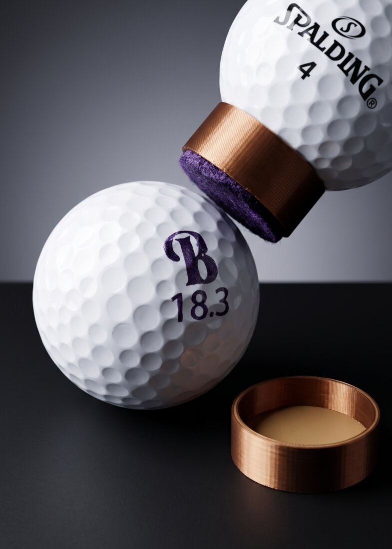 Golf ball stamped with a custom symbol or crest mark